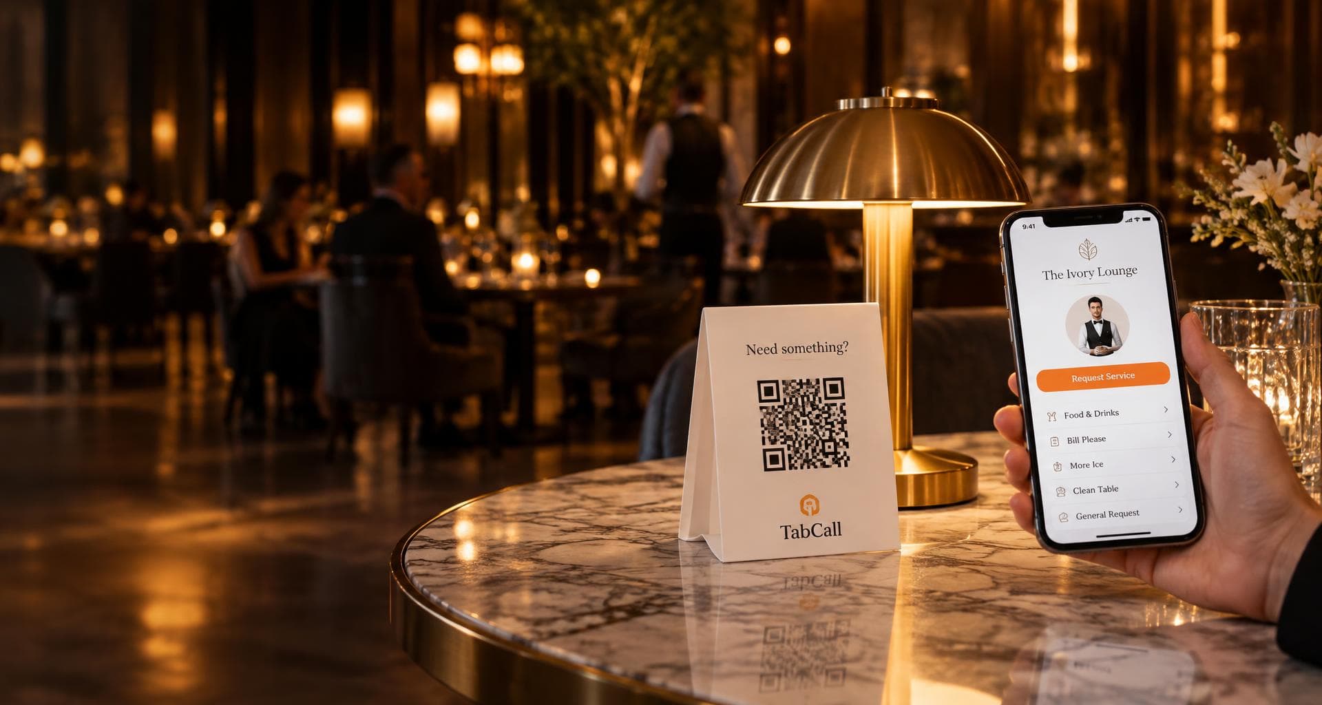 TabCall QR service stand and guest phone on a warmly lit restaurant table
